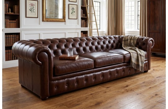 Skórzana sofa 3 osobowa chesterfield Duero w brązowej skórze, w salonie z biblioteczką