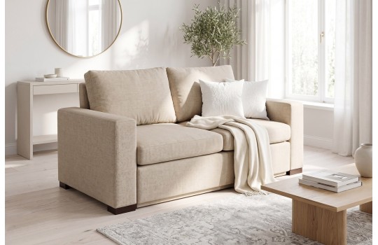 Beżowa sofa Riga z funkcją spania w jasnym wnętrzu