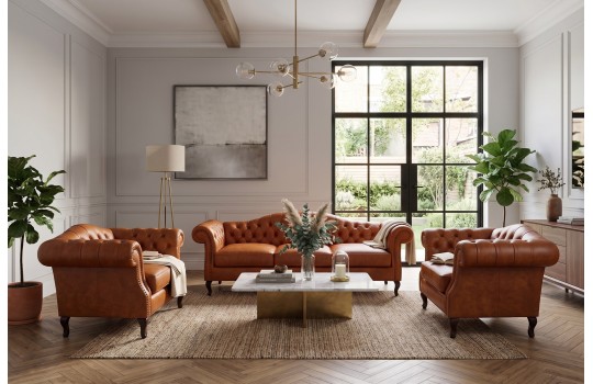 Zestaw wypoczynkowy ze skóry z fotelem chesterfield Solano i sofą w loftowym salonie Zestaw wypoczynkowy ze skóry z fotelem chesterfield Solano i sofą w loftowym salonie