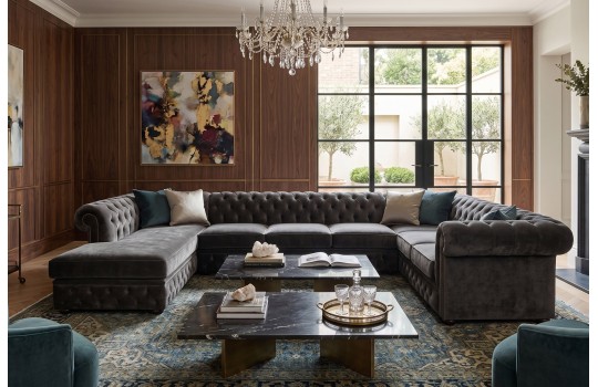Duży salon z ciemnym narożnikiem chesterfield U Deko i stolikiem kawowym Duży salon z ciemnym narożnikiem chesterfield U Deko i stolikiem kawowym