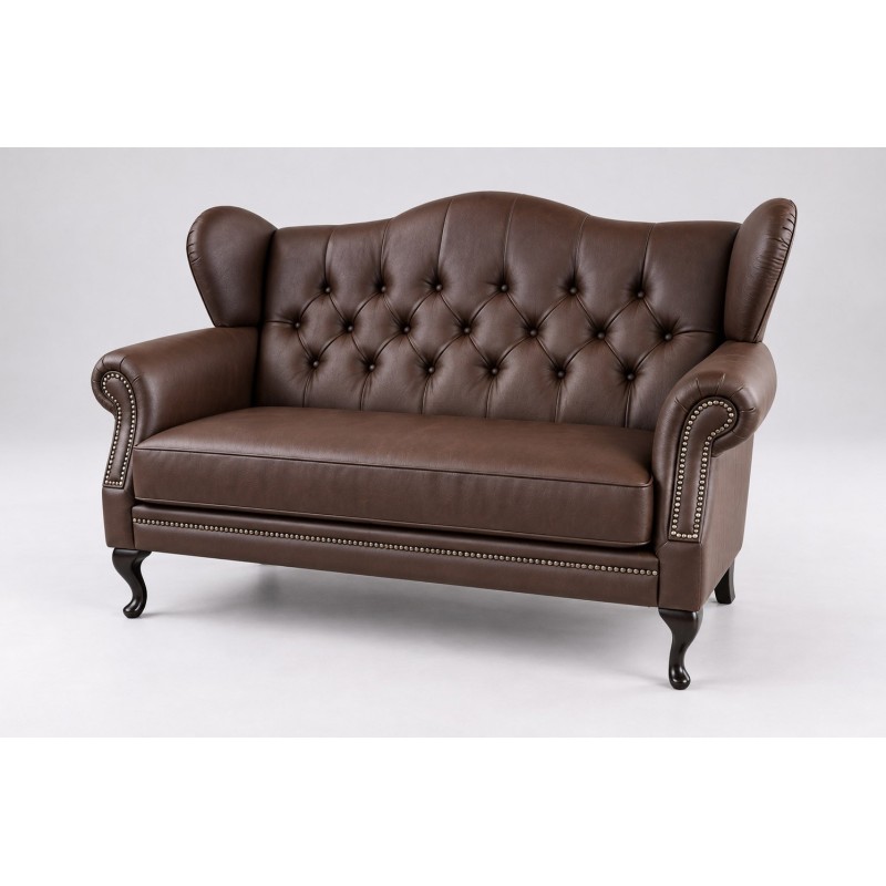 Ciemnobrązowa skórzana sofa uszak Aloha z ćwiekami wzdłuż podłokietników Ciemnobrązowa skórzana sofa uszak Aloha z ćwiekami wzdłuż podłokietników